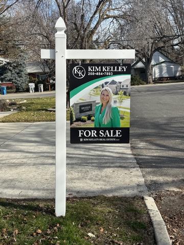 Kim Kelley Real Estate photo For Sale sign on a white vinyl post
