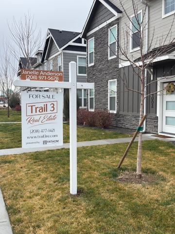 Trail 3 Real Estate listing sign with name rider on a white post