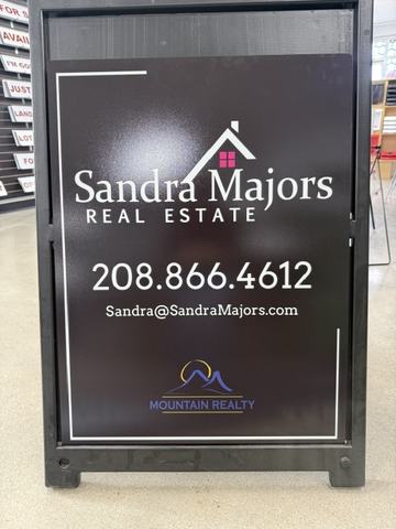 Sandra Majors Real Estate panel in a black A frame
